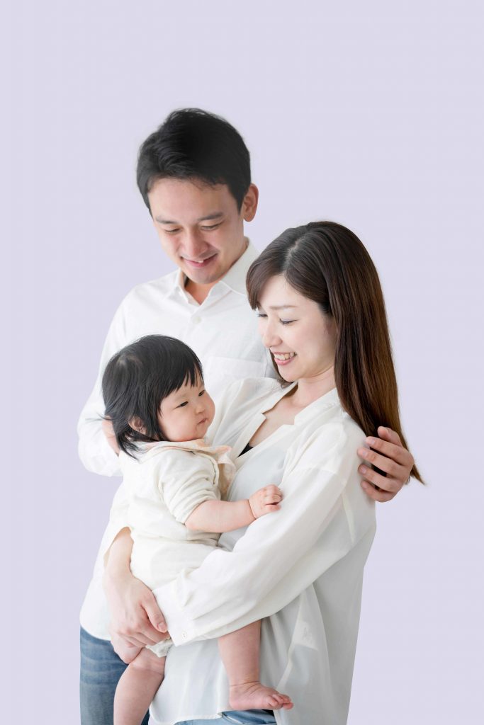 mom carrying baby with husband around